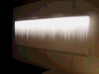 horizontal array of 84 vertical fluorescent tubes,top halves 
glowing
