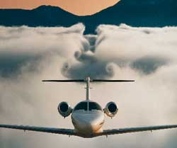 A Cessna Citation leaves a deep trough in the clouds beneath it, proof that it stays aloft by pushing air down. 